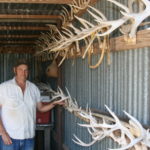 Dunegan shows off his antler wall. Many of these were taken while hunting out of a pirogue.