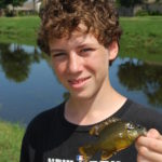 Connor Pugh shows off a small but mature green sunfish taken from a Metairie drainage canal.