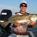 Capt. T-Man Cheramie holds a 5-pound trout caught on topwater bait in Lake Raccourci.