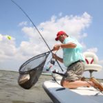 New Iberia’s Leon Minvielle lands a hard-fighting redfish.