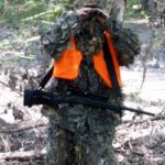 Binoculars come in handy to scan the distant woods, and a safari sling keeps the rifle within easy reach even when the hands are occupied.
