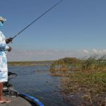 Bassmaster Elite pro Ish Monroe uses a Simms gaiter and lightweight clothing in a sky/cloud pattern to minimize his presence in front of fish.