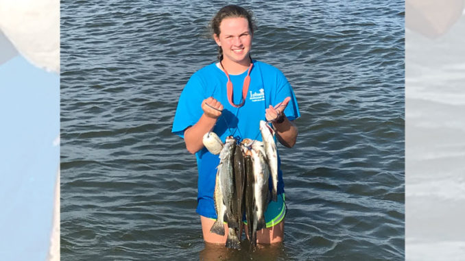 Laura Burch, 14, with a nice mess of trout caught while wade fishing out of her family's camp.
