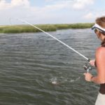 Dena Woerner puts the brakes on a spunky marsh redfish.
