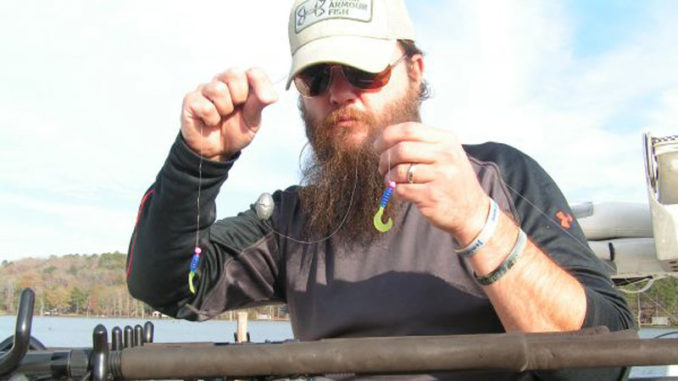 Jay Stone shows the bottom two 1/16-ounce jigs and 2-ounce bell weight of a kitchen sink rig.