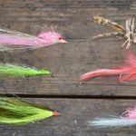 Six of del Rio’s favorite saltwater fly patterns are, starting in top row on the left, a Clouser, a crab pattern, another Clouser, a seducer, a deceiver and a pink Charlie (better known as a bonefish fly).