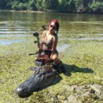 Christina Rivers poses with the 14-foot, 1-inch alligator she and her dad, Roger, harvested north of Toledo Bend on Sunday, Sept. 20.