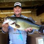 Derek Mong, 36, of Many, displays his huge Toledo Bend lunker bass.