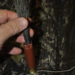 5) Push the base of the beard into the shotgun shell until it is in the caulk. How much beard you want hanging out the end of the shell is your choice.