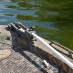 Tregle’s PVC pipe anchor is clamped loosely enough in the trolling motor bracket that it can be pulled up to the expanded portion of the pipe near its point without coming out of the clamp. Note the pointed tip on the wooden insert, which makes it easier