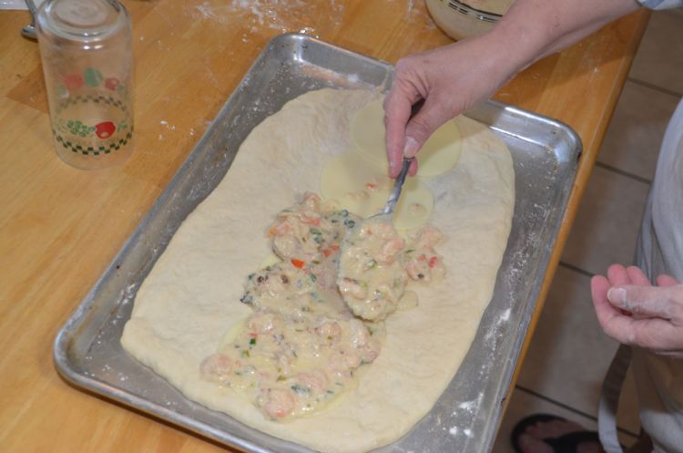 Spoon the seafood evenly over the cheese down the center of the bread dough.