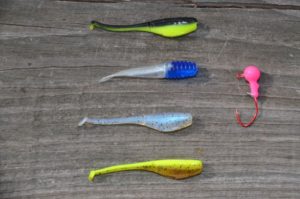 Josh Andrews’ four favorite colors for jig tails are, from the top, lights out, blue pearl, monkey milk and sweet tea with lemon. Note the sickle hook on the jighead on the right.