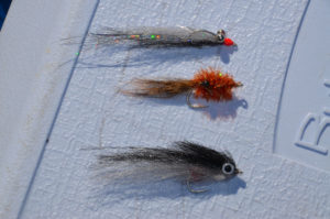 Tedesco’s three mainstay flies for speckled trout are, top to bottom: a Clouser minnow, a shrimp imitation and a Puglisi peanut bunker. Note the predominance of gray and black. 