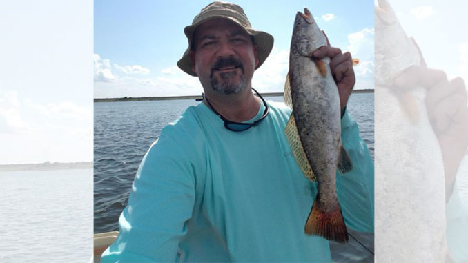 Joey Jeanfreau shows off a nice speckled trout, and said Chalmette locations typically get hot from October through about April.