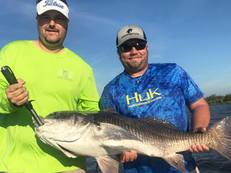Capt. Nick Rando (right), owner of Fishaholic Fishing Charters, with Allen Buckley and a 45-pound black drum caught on shrimp under a Four-Horsemen popping cork in the Lost Lake area.