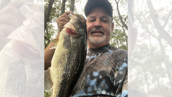 Mike “Pickle” Fontenot of Ville Platte holds one of the hawgs he has caught fishing Chicot Lake.