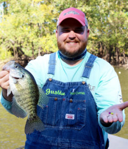 Justin Maxwell shows his favorite plastic tail bait, Southern Pro Popsicle, and one of the day’s catch.