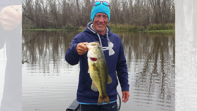 Barry Henry smiles as he holds a nice-sized bass caught on a cold winter’s day in the Crackerhead area of Lake Verret while fishing with Bill McCarty of Morgan City.