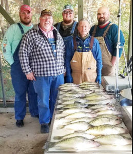 A nice mess of crappie taken at a recent crappie.com gathering by, from left, Justin, Warren and Josh Maxwell with Bud Wilson and David Bartlett.