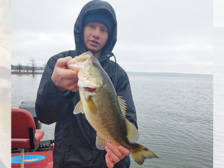 Curt Crool’s son proudly holds a nice-sized bass, one of 35 he caught while working a suspending gold/orange Rogue on a bitterly cold January day with John Dean at Toledo Bend.