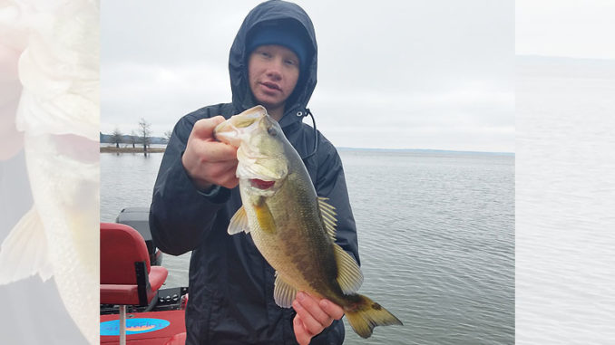 Curt Crool’s son proudly holds a nice-sized bass, one of 35 he caught while working a suspending gold/orange Rogue on a bitterly cold January day with John Dean at Toledo Bend.