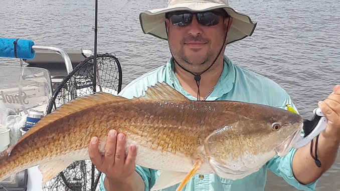 Scott Baker of Arkansas shows off a nice red caught with Smokin’ Reels Charters out of Lydia.