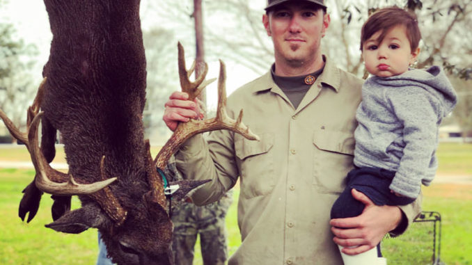Dillon Savoy and his 16-month-old son Ryder pose with the big buck he shot on Jan. 17 at the White Castle Hunting Club in Iberville Parish.
