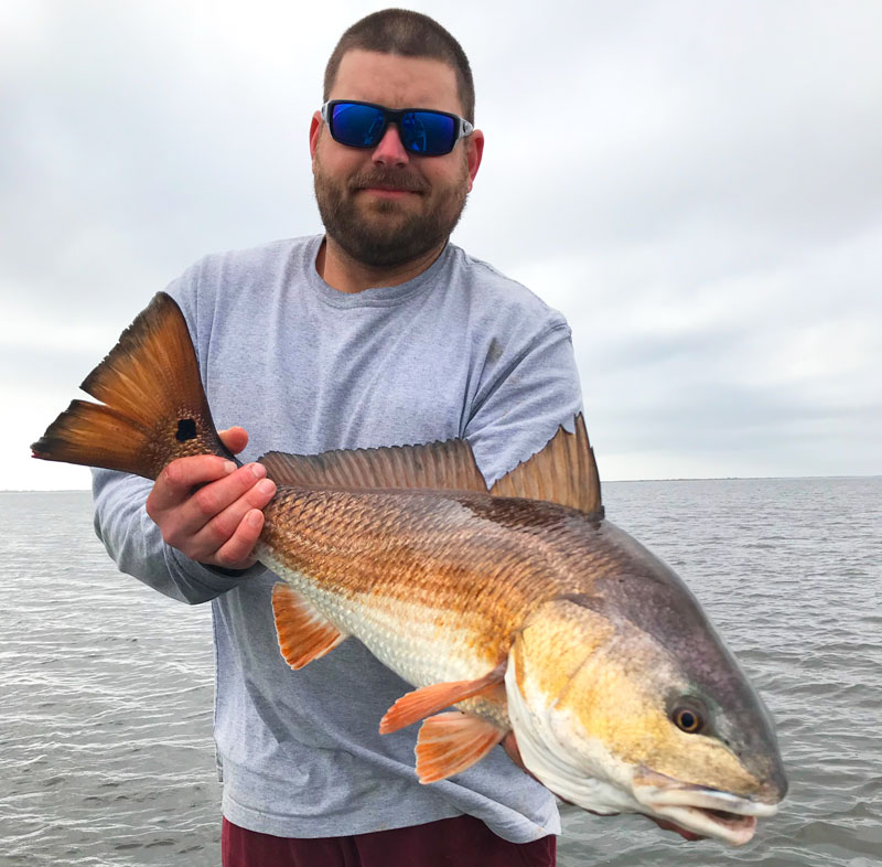 In April, redfish often gravitate toward fresh river water. Here’s Ryan Bourgeois with a bronze-colored bull.