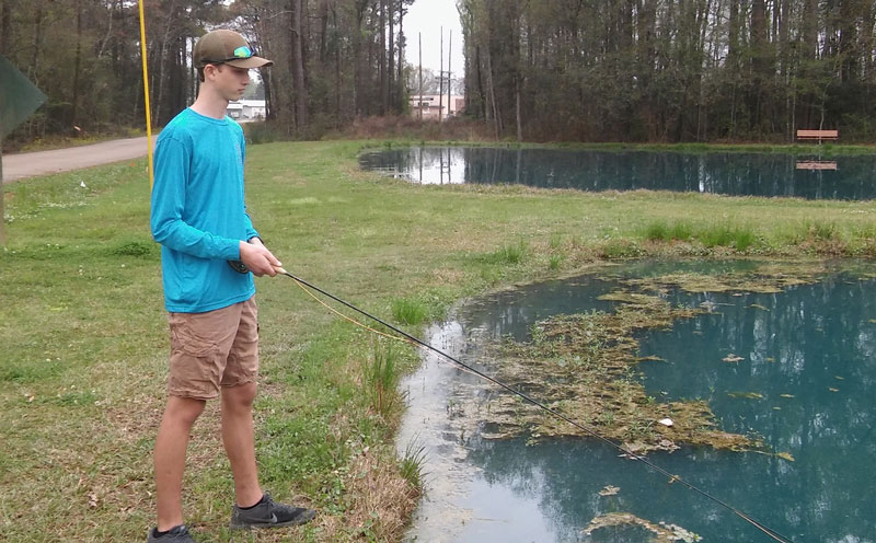 Alex Rodrigue, a freshman at St. Micheal High School and member of the school's fly fishing club, fishes the LDWF Waddill Refuge ponds for bass.