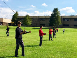 Some members of the St. Michael Fly Fishing Club practice casting on school grounds at one of their after-school meetings. Only half the members can practice at one time due to shortage of equipment.