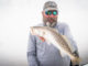 Jeff Poe on a foggy day with a nice speckled trout.
