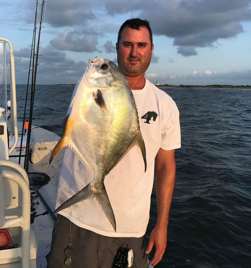 Capt. Aaron Pierce holding a 4-pound permit caught at the East Timbalier rocks.