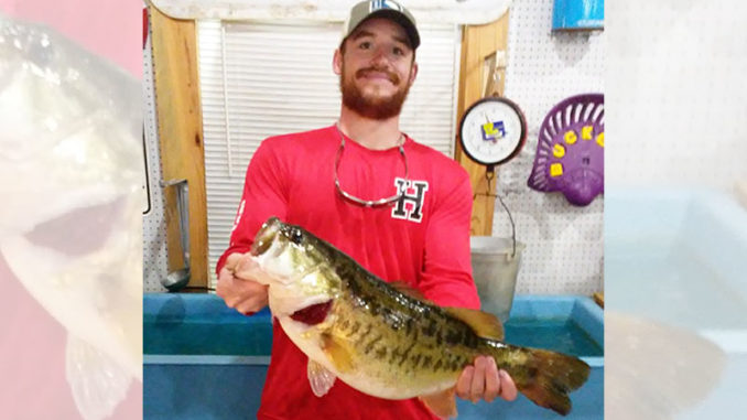 Garrett Perkins, of Mamou, poses with the big 10.46-pound bass he caught from a bed on March 25 in the Negreet area at Toledo Bend. The big fish finally bit a Texas-rigged white Cajun Lures Craw after about 25 or 30 flips, he said. (Photo courtesy of Toledo Bend Lake Association)