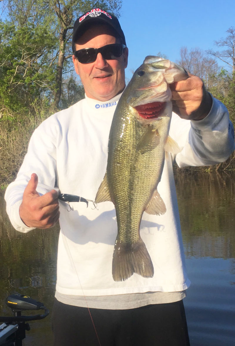 Chester Begnaud shows a nice bass caught on a black Whopper Plopper at Henderson Lake.