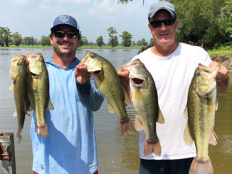 Paul Begnaud, left, and his father, Chester Begnaud, hold five bass that went 16.89 pounds on the first day of the Henderson Lake Dog Fight Classic in 2018.