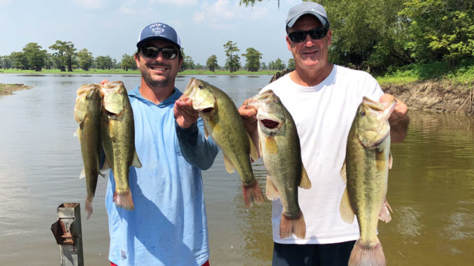 Paul Begnaud, left, and his father, Chester Begnaud, hold five bass that went 16.89 pounds on the first day of the Henderson Lake Dog Fight Classic in 2018.