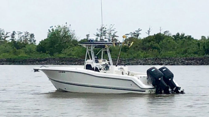 Boats like this one near Pilottown have been running aground on newly formed sandbars that were created when the Mississippi River reached near record-breaking highs earlier this spring and summer. As the river drops, anglers are urged to use caution because of sediment and obstacles deposited during the high-water conditions. (Photo by Sea Tow Westbank)