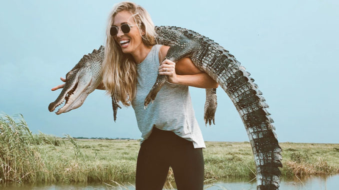 Caitlin Scates of Ponchatoula with her “gator necklace” from a Sept. 21 trip to the Orleans Parish marsh. Will sport-hunting of Louisiana’s alligators control the population if commercial efforts plummet due to a shrinking market for skins?