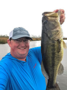 Raceland’s David King displays one of the heaviest bass taken following a front passing through on Lac Des Allemands Feb. 5. Altogether King and his fishing partner, David McMath scored on approximately 40 bass with the better fish ranging from 2 to 5 pounds.