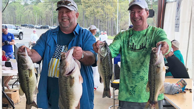 Paul Resweber, left, holds a 10.07-pound bass in his left hand after weighing in a limit on March 15, the second day of the Texas Oilman's Bass Invitational at Toledo Bend. Resweber, who lives in St. Martinville, and Mike O'Brien of New Iberia, finished third that day with 22.18 pounds and 25th overall with 33.24 pounds. (Photo courtesy Sherrie Resweber)