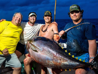 Mike McElroy III (far right) was on the rod when the crew of the Hook N Bull (from left, Mike McElroy II, Ryeley Jacobs and Luke Myers) landed a 236.6-pound yellowfin tuna out of Pass Christian, Miss., that appears to be a Mississippi state record. (Photo by John Michael Gory)
