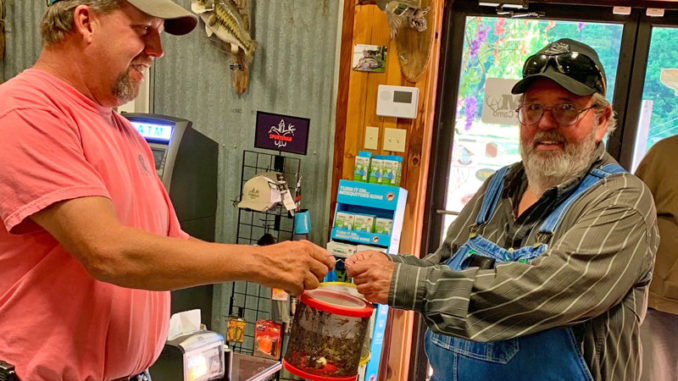 Kenny Kavanaugh serves up a bucket of crickets to a customer at K&M in Farmerville.