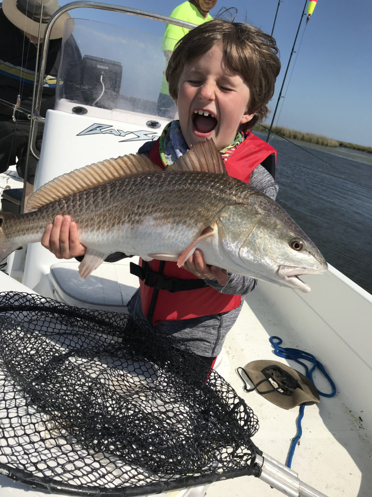 Son's first bull red at Delacroix Island
