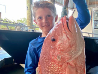 Six-year-old William Bass proudly displays a beautiful red snapper.