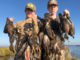 Jacob and Christian Mire holding up a four-man limit of Delacroix ducks.