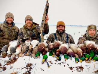 Cole Barthel (left) and a group of Simmons’ Sporting Goods hunters limited out Monday morning hunting in the rare north Louisiana snow.