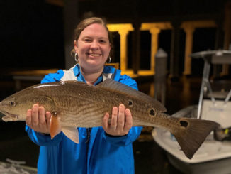 Participant shows off her catch after learning new skills at 2020 Women's Fishing Workshop