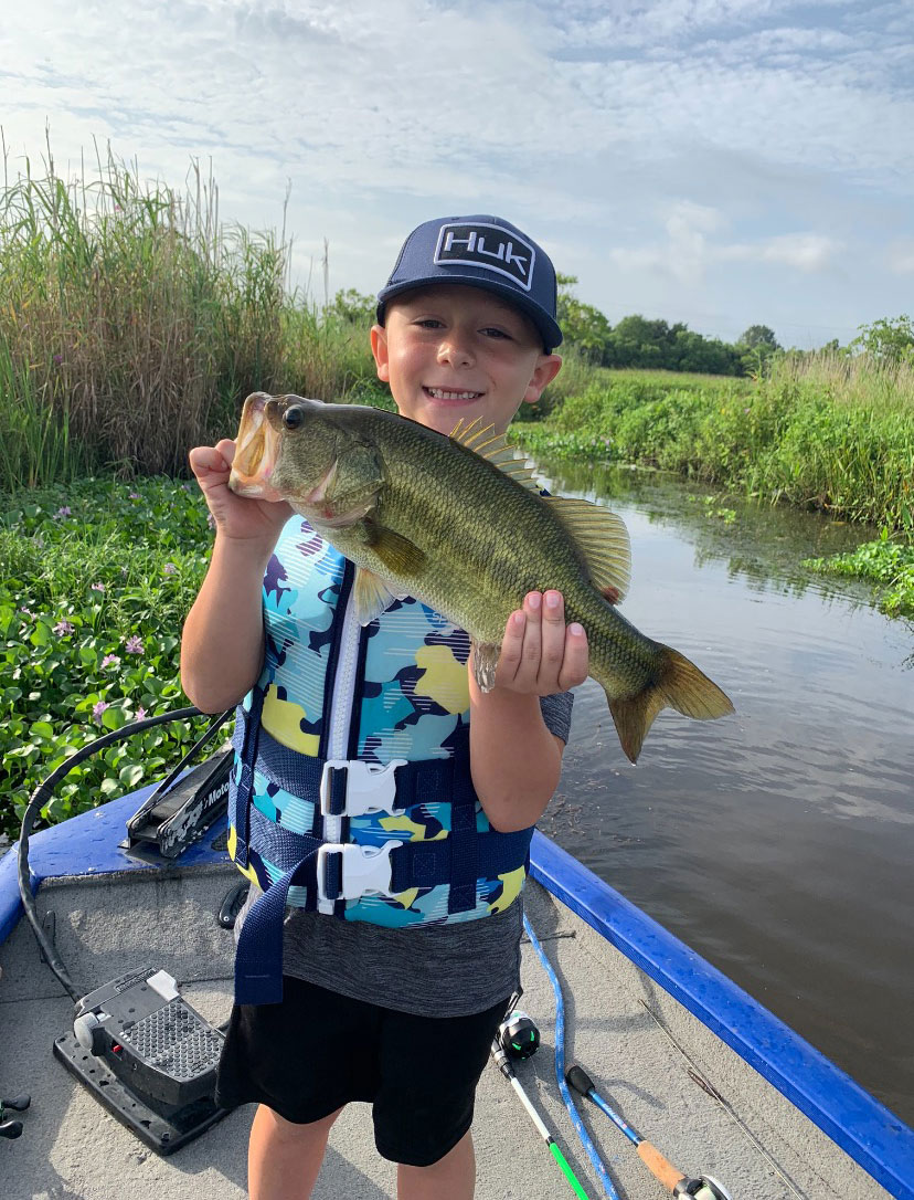 As the water temperature begins to rise, solid bass like this one Noah McFarlane is holding will start to hit a Spro frog viciously.