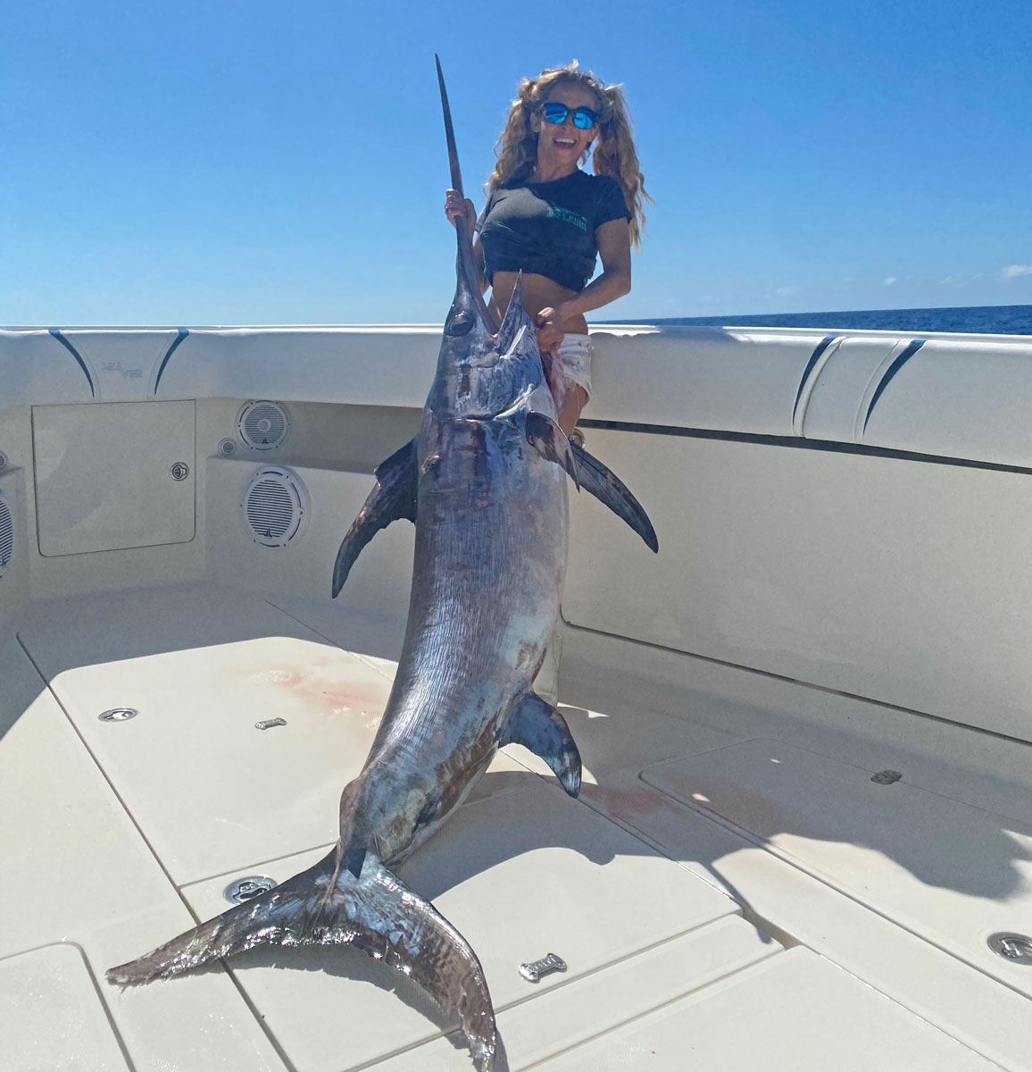 London Rosiere poses with her “smaller” swordfish, a 130-pounder that just warmed her up for her two-hour plus battle with a much bigger one minutes later.