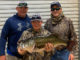 Ollie Pruett Slaughter (right) of Prairieville caught this 11.82-pound bass at Toledo Bend on May 2.